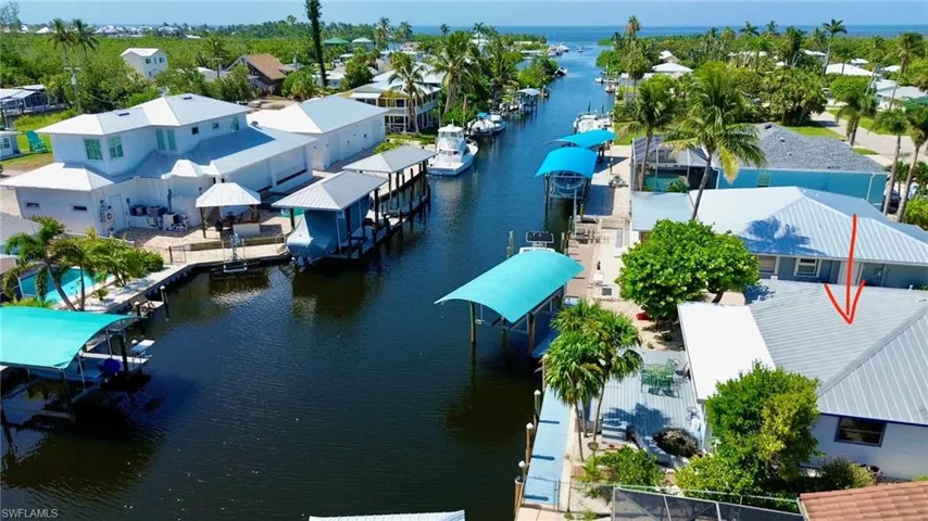 Aerial view of residential area featuring a large body of water