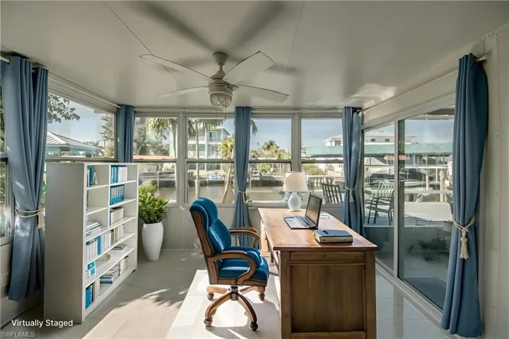 Office with ceiling fan and a water view