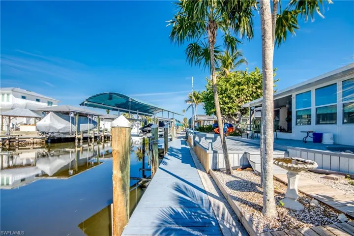 Dock area with a water view and boat lift
