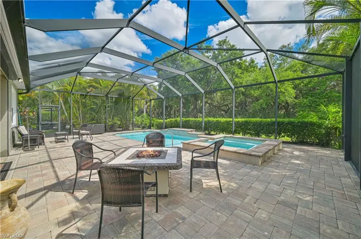 Beautiful Lanai Area with heated pool, spa built-in gas firepit, & outdoor kitchen