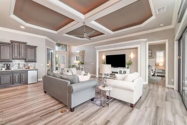 Living area featuring light wood-style floors, visible vents, and baseboards