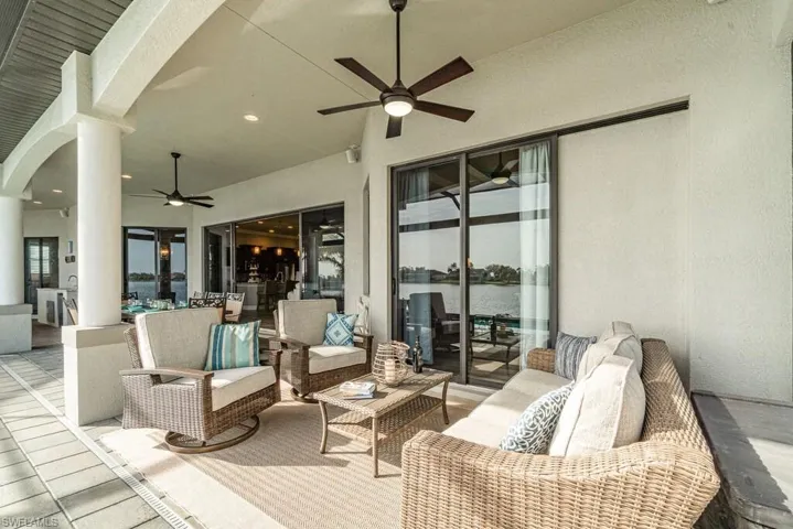 View of patio / terrace featuring ceiling fan, outdoor dining area, outdoor lounge area, and a water view