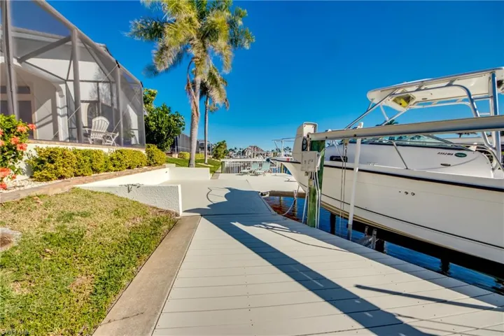 View of dock with a lanai and boat lift