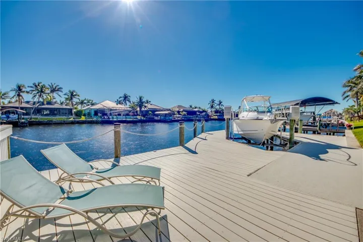 View of dock with boat lift and a water view