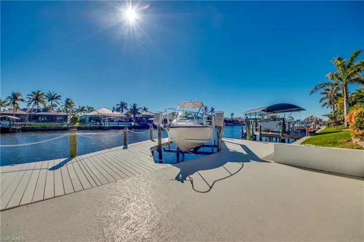 Dock area with a water view and boat lift