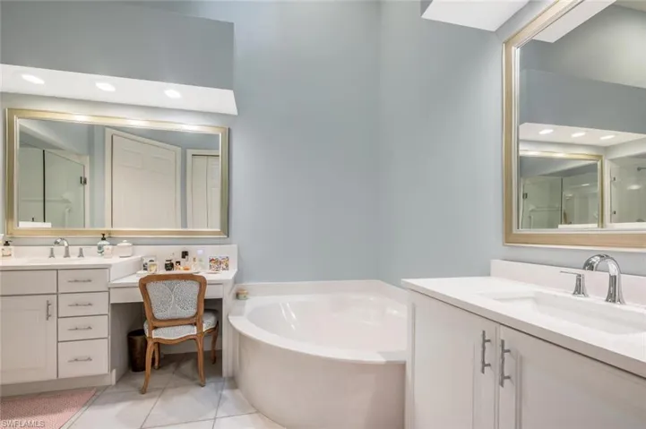 Primary Bathroom ensuite with Custom Mirrors, dual Separate updated Sinks, counter tops, and faucets