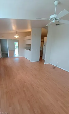 Unfurnished living room featuring ceiling fan and light wood finished floors
