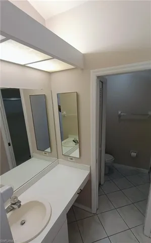 Bathroom with tile patterned floors and vanity