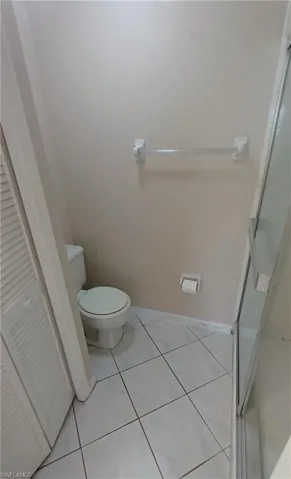 Bathroom with a shower stall and tile patterned floors