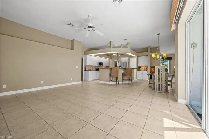 The neutral patterned floors are decorative and flow into the kitchen and breakfast areas.