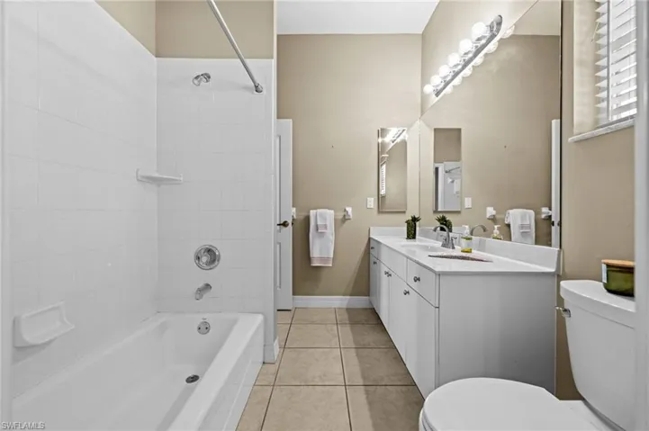 Bathroom number three features a shower / bathtub combination. The vanity is quite large.