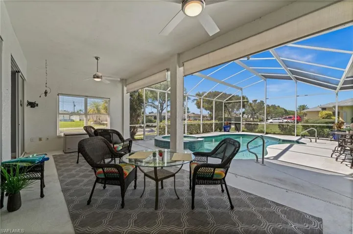 This outdoor oasis includes your pool with a connected hot tub, and decorative lighted fans.