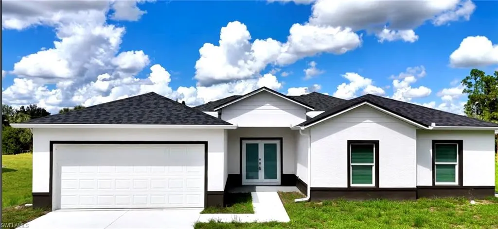 Ranch-style house featuring concrete driveway, a garage, a shingled roof, stucco siding, and a front yard