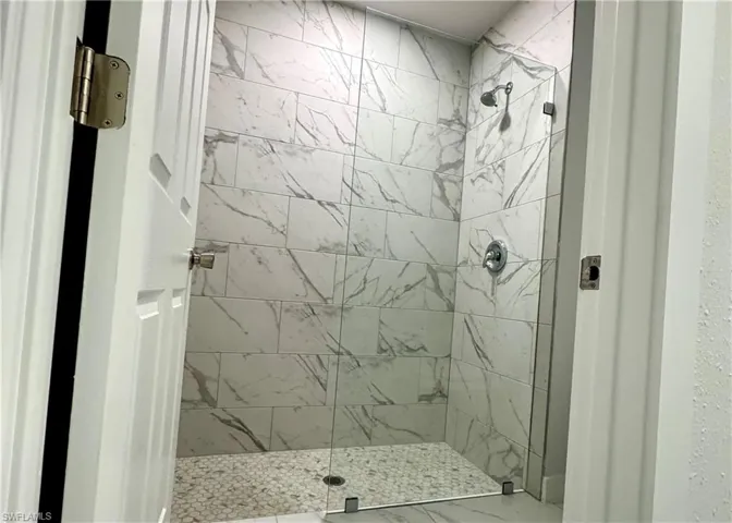 Full bathroom featuring a tile shower