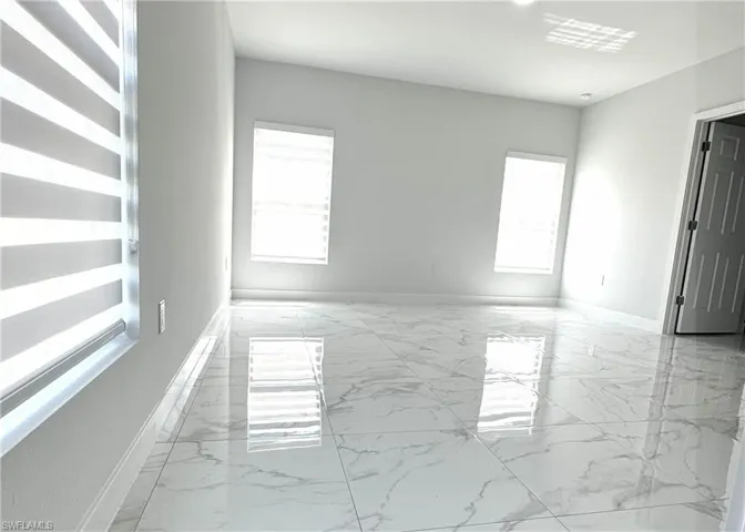 Empty room featuring baseboards and light marble finish flooring
