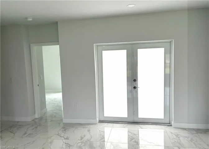 Entryway with french doors and marble look tile flooring