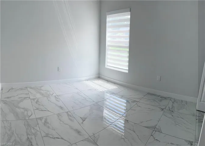 Empty room with light marble finish flooring and baseboards