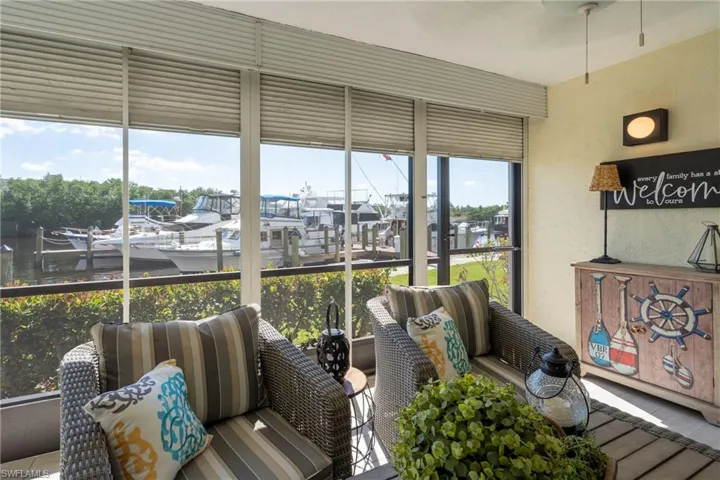 Sunroom / solarium with a water view and a textured wall