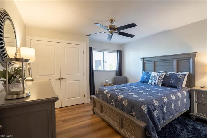 Bedroom with wood finished floors, a closet, and a ceiling fan