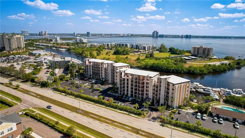View of urban area featuring apartment complex and a nearby body of water