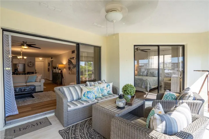 Sunroom featuring ceiling fan, an outdoor living space, healthy amount of natural light, and a deck