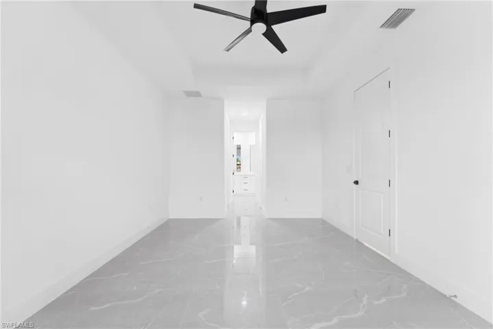 Unfurnished room featuring ceiling fan