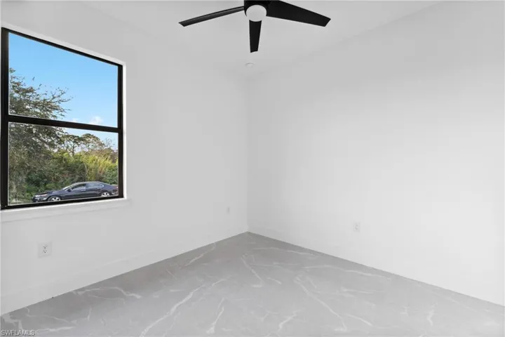 Empty room with plenty of natural light and ceiling fan