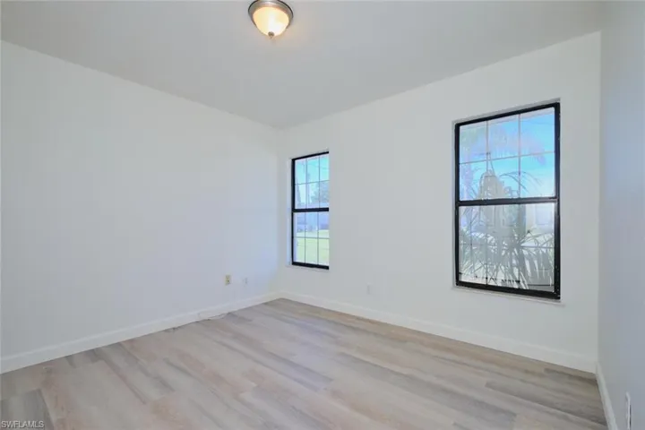 Unfurnished room with light wood-type flooring and a wealth of natural light