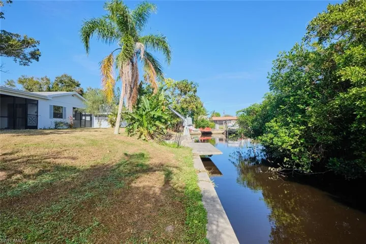 View of yard featuring a water view and a boat dock
