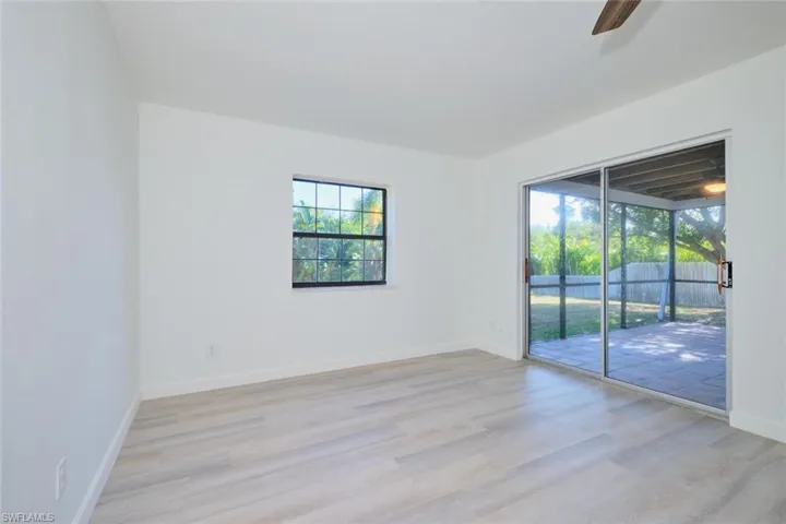 Unfurnished room featuring ceiling fan and light wood-type flooring
