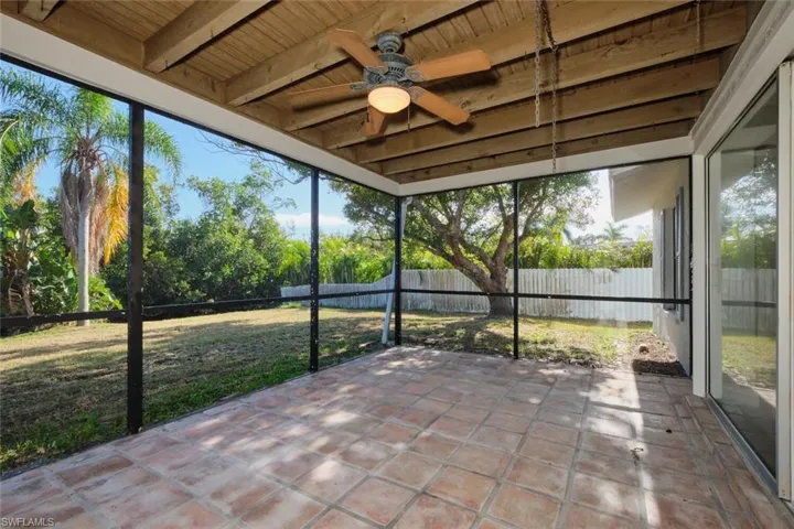 Unfurnished sunroom with beamed ceiling and wood ceiling