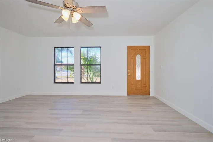 Empty room featuring ceiling fan and light wood-type flooring