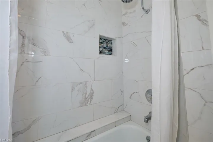 Bathroom with shower / tub combo with curtain