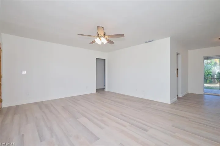 Unfurnished room with ceiling fan and light hardwood / wood-style floors