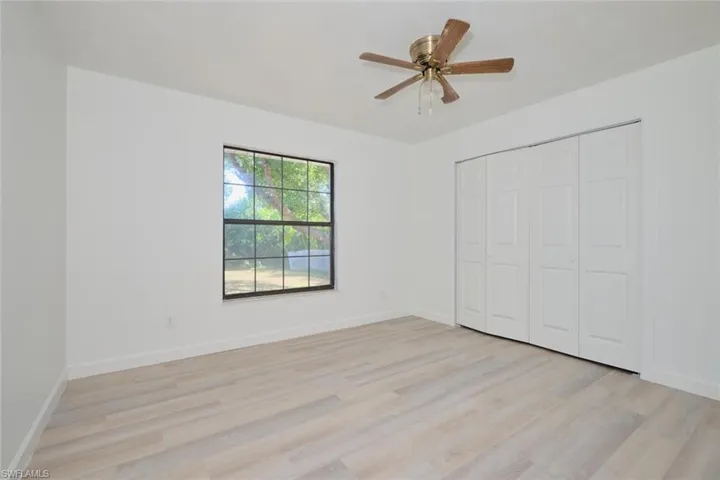Unfurnished bedroom with ceiling fan, light hardwood / wood-style floors, and a closet