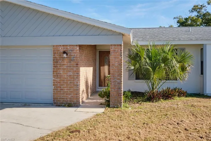 Doorway to property with a garage