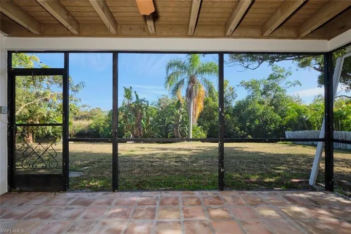 Unfurnished sunroom featuring beam ceiling and wood ceiling
