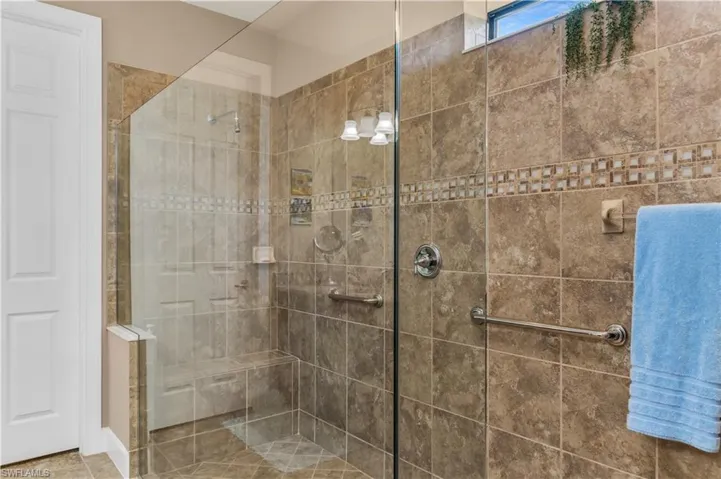 Bathroom featuring tile flooring and an enclosed shower