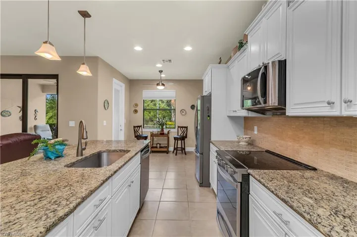 KitchenFeaturing A Generous Island and Counterspace, As Well As A Flat Top Range For A More Streamline Appearance.