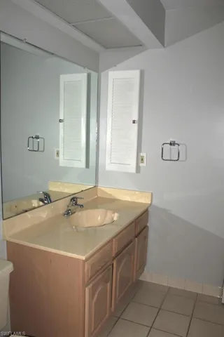 Bathroom with tile patterned flooring, vanity, and toilet