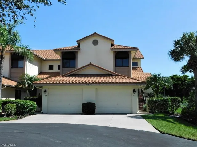 Mediterranean / spanish-style house with stucco siding, driveway, a tile roof, and a garage