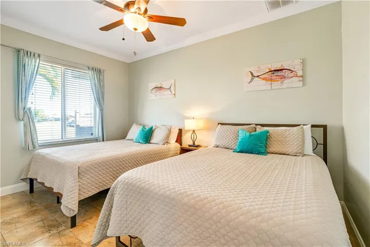 Bedroom featuring ornamental molding and ceiling fan