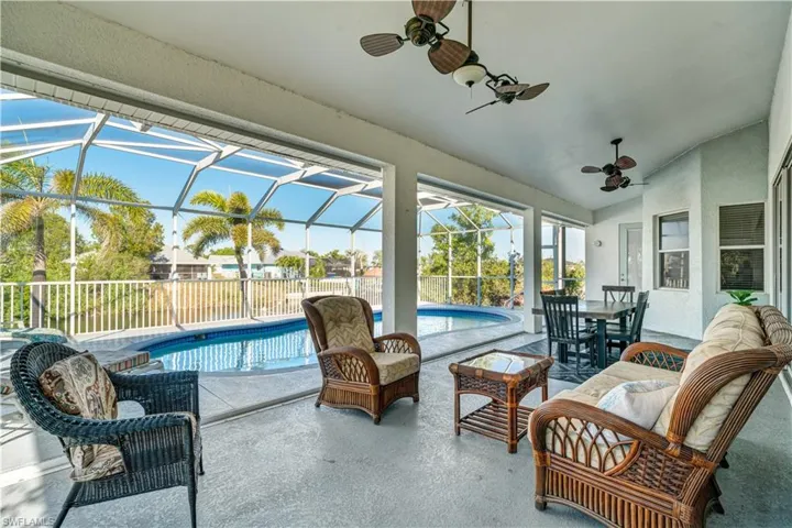Sunroom with lofted ceiling, a patio area, ceiling fan, outdoor dining space, and outdoor lounge area