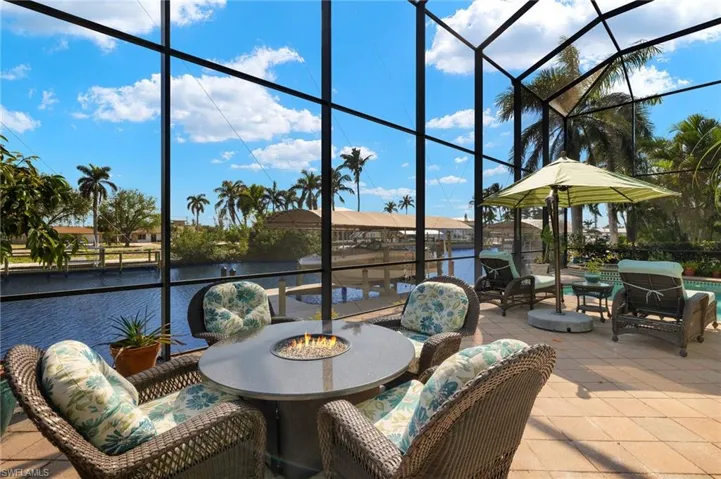 Lanai featuring an outdoor fire pit and a water view