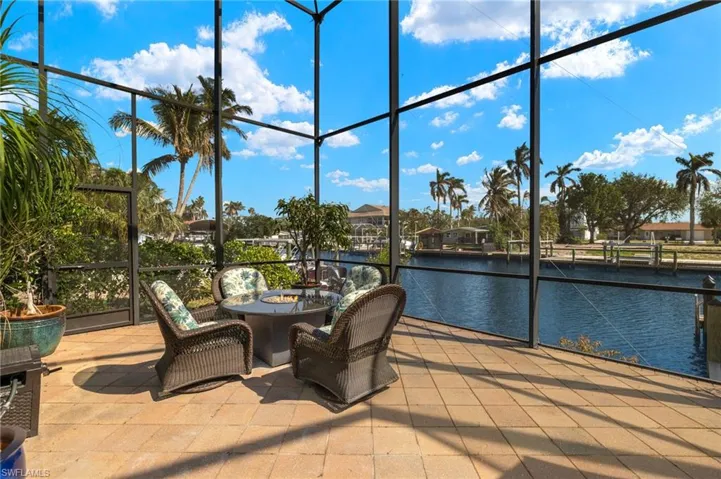 View of Firepit, 2-story enclosed screened-in area, and canal.
