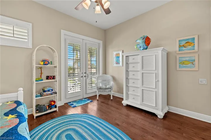 Guest bedroom with French doors leading to balcony