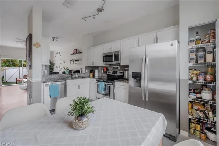 Kitchen featuring white cabinets and stainless steel appliances