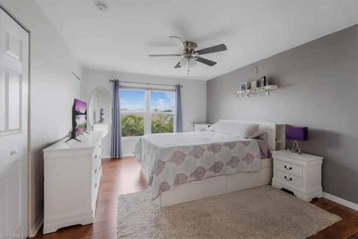 Bedroom with hardwood / wood-style floors and ceiling fan