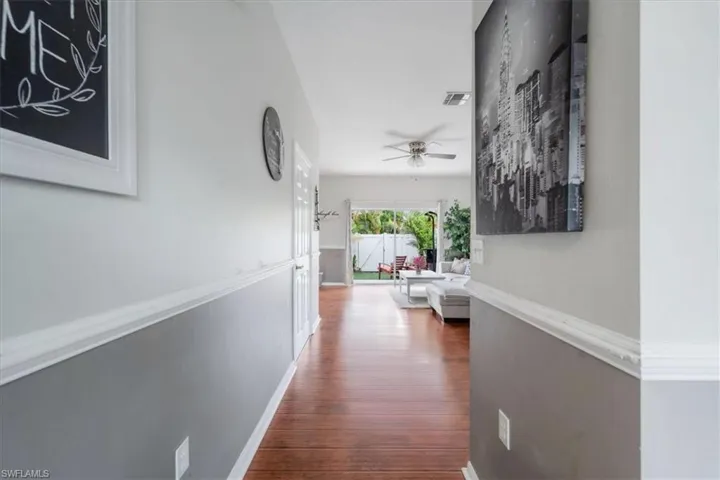 Corridor with hardwood / wood-style flooring