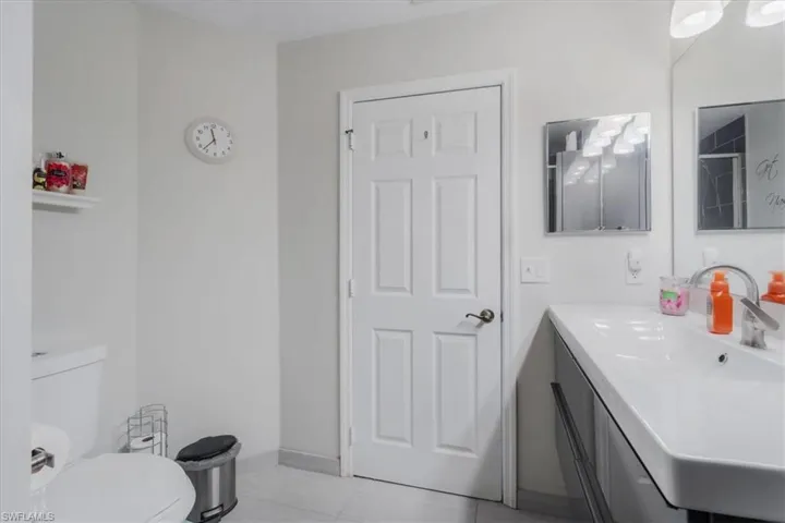 Bathroom with vanity, toilet, and tile patterned flooring